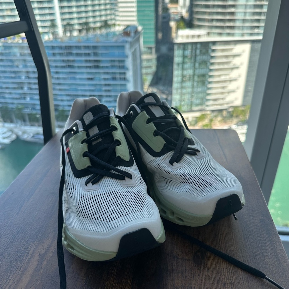 On Running Black and White Sneakers with Green Accents